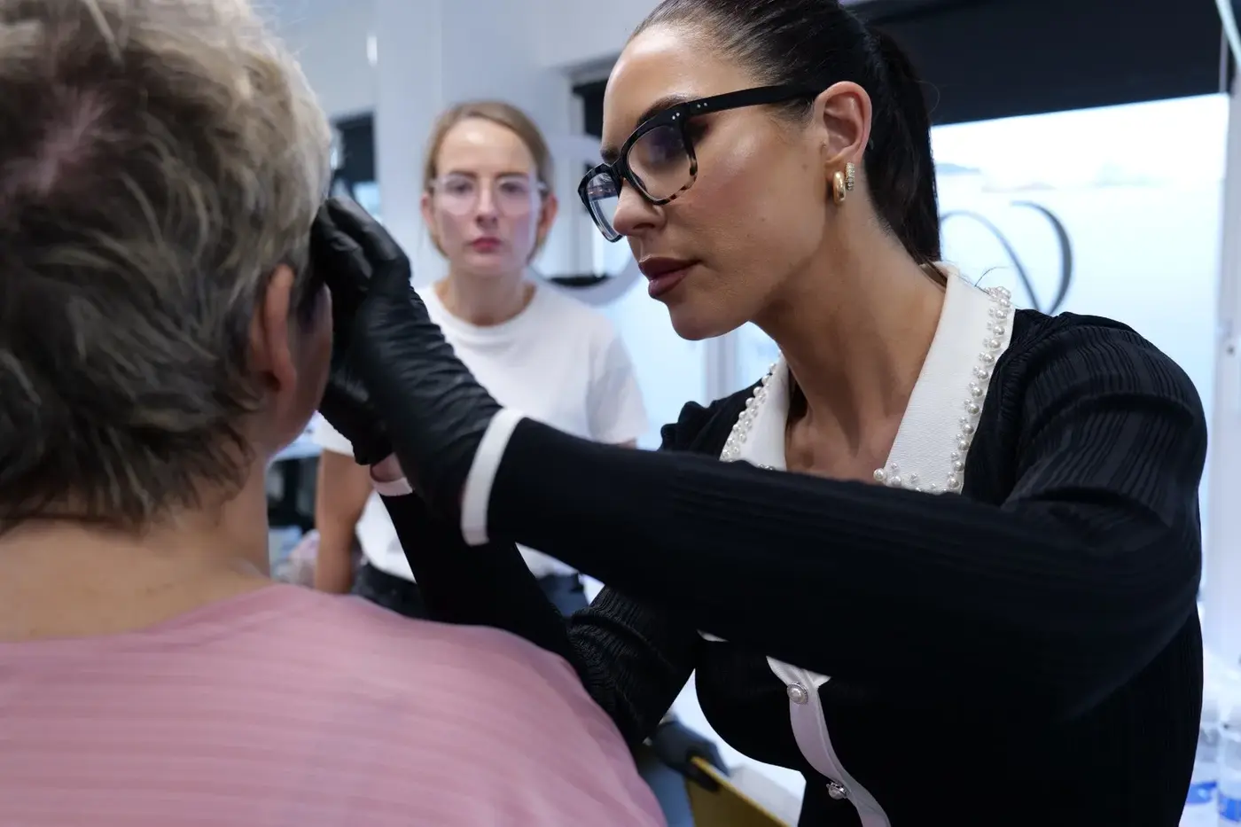 Lorraine pre-drawing the eyebrow design with a soft pencil before tattoo, showing precision approach