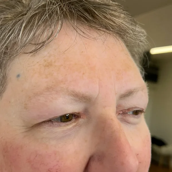 Uneven fine mature brows showing asymmetry before balanced tattoo