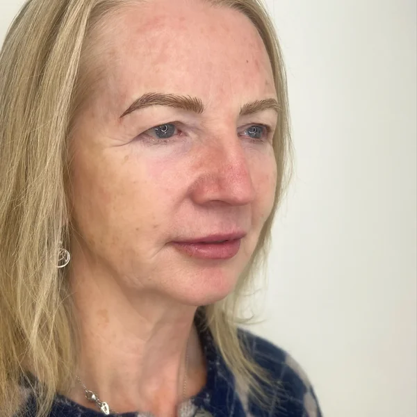 3D feather brows on mature blonde — fuller eyebrow result, soft warm tone