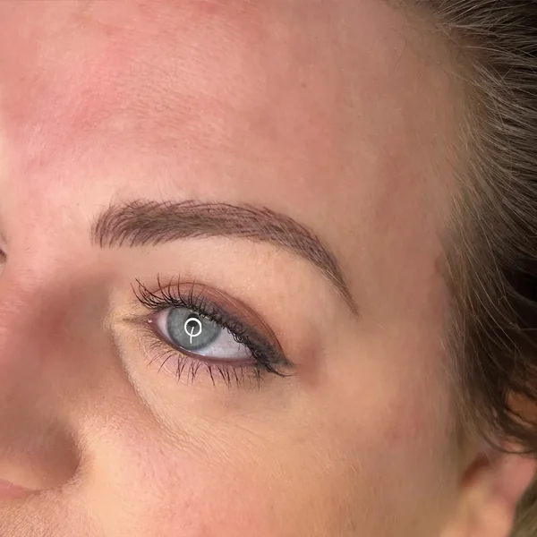 Fresh eyeliner tattoo on mature blue eyes — wake-up-ready definition