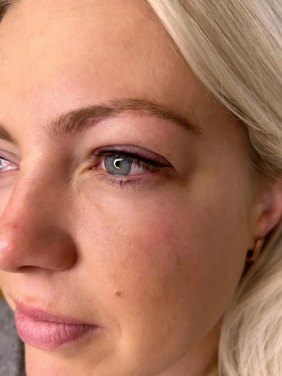 Subtle eyeliner tattoo result — blue eyes, blonde client, natural definition by Lorraine