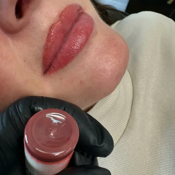 Healed lip blush — deep red, close-up showing colour saturation